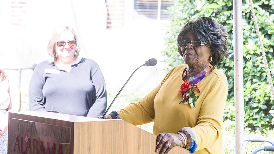 Autherine Lucy Foster stands at a podium.