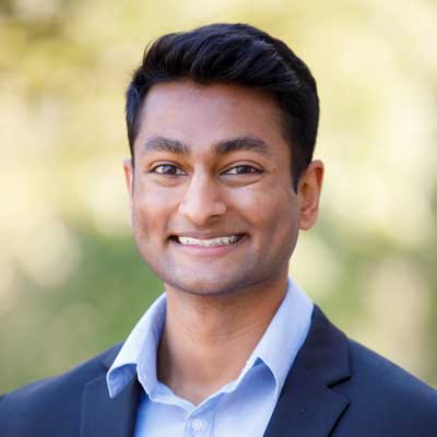 Profile image of Tejas Dinesh wearing a blazer and collared shirt.