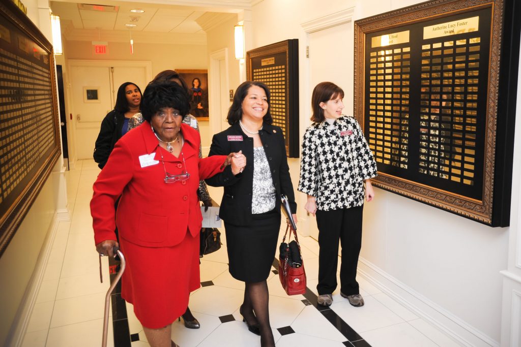 Dr. Autherine Lucy Foster walking down a hallway with two other women