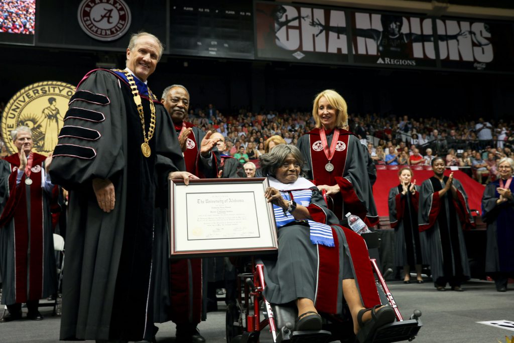 Dr. Foster on stage receiving her honorary doctorate of human letters from Dr. Bell