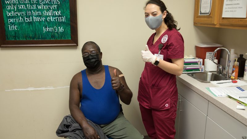 A nurse and patient giving a thumbs up