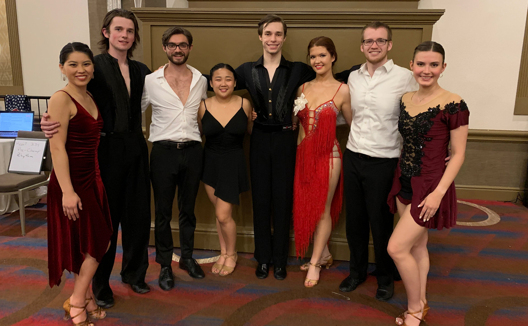 Several members of the ballroom dance team posing before the competition