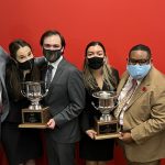 Members of the Alabama Forensic Council hold two trophies