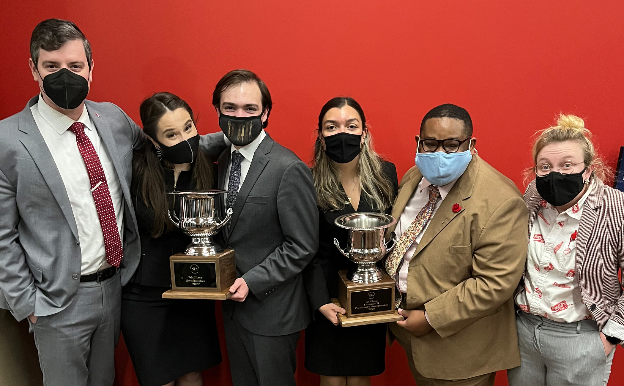 Members of the Alabama Forensic Council hold two trophies
