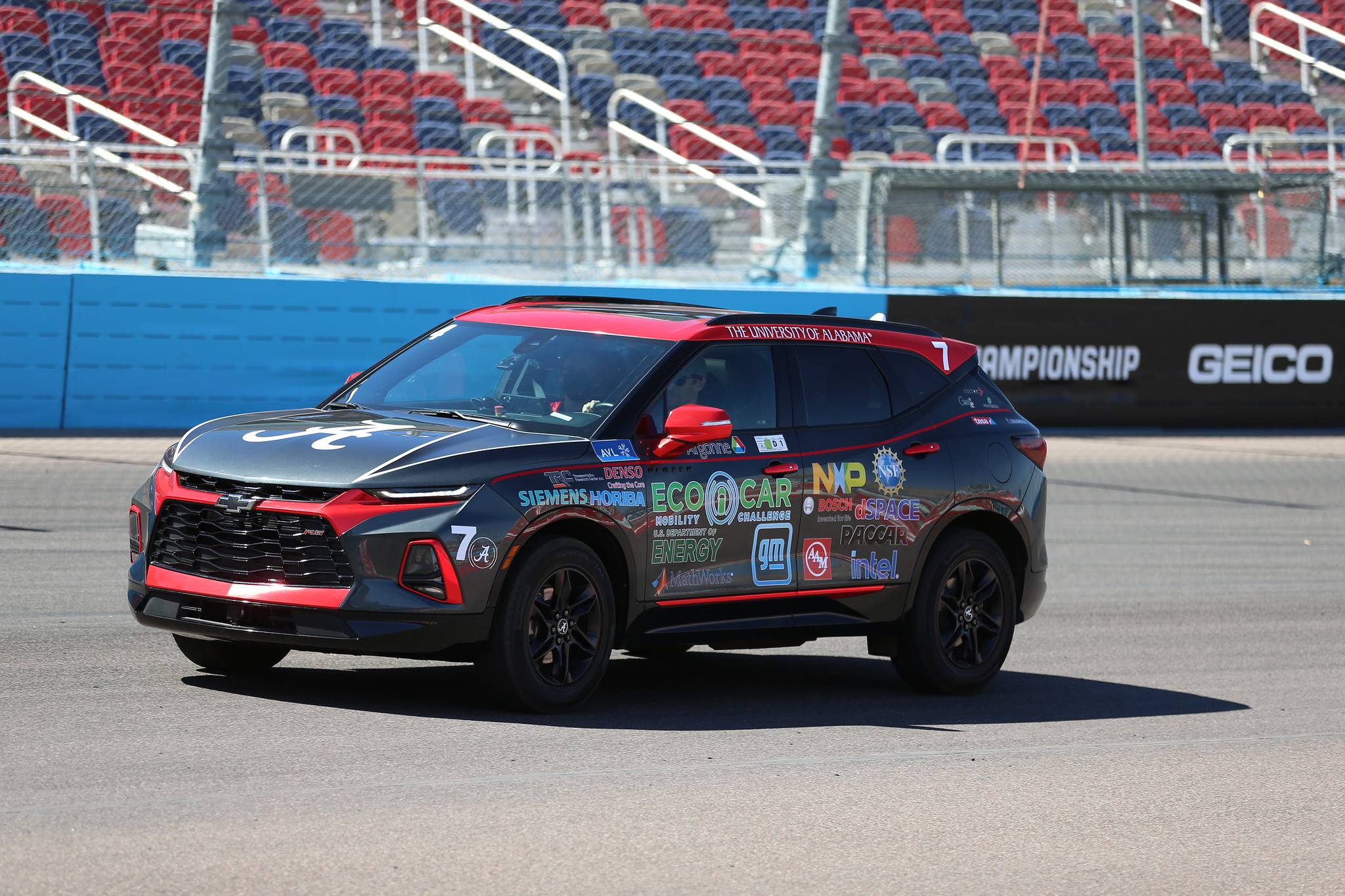 An SUV with a The University of Alabama logo on a racetrack.