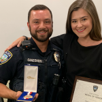UAPD Officer Albert Canzoneri holds his medal of honor as he stands next to his wife, Shannon.
