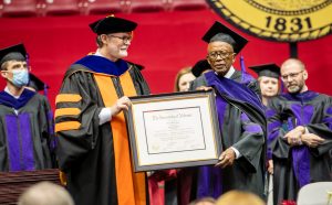 Law school Dean Mark Brandon presents Fred Gray with his honorary degree