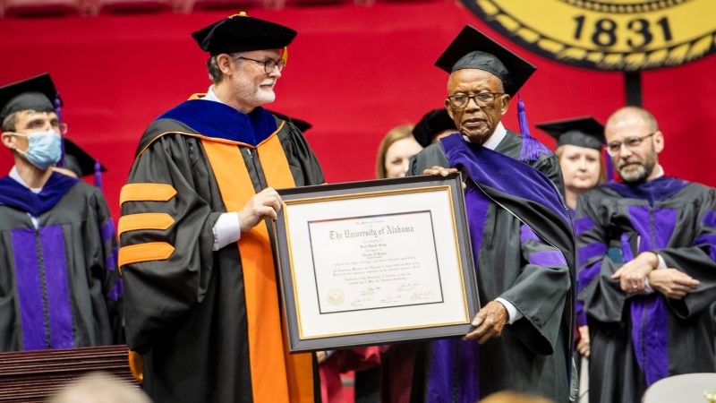Law school Dean Mark Brandon presents Fred Gray with his honorary degree