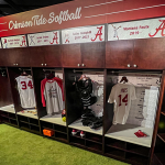 A set of lockers with softball equipment in them.