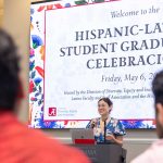A woman speaks to an audience at the Hispanic-Latino Celebracion.