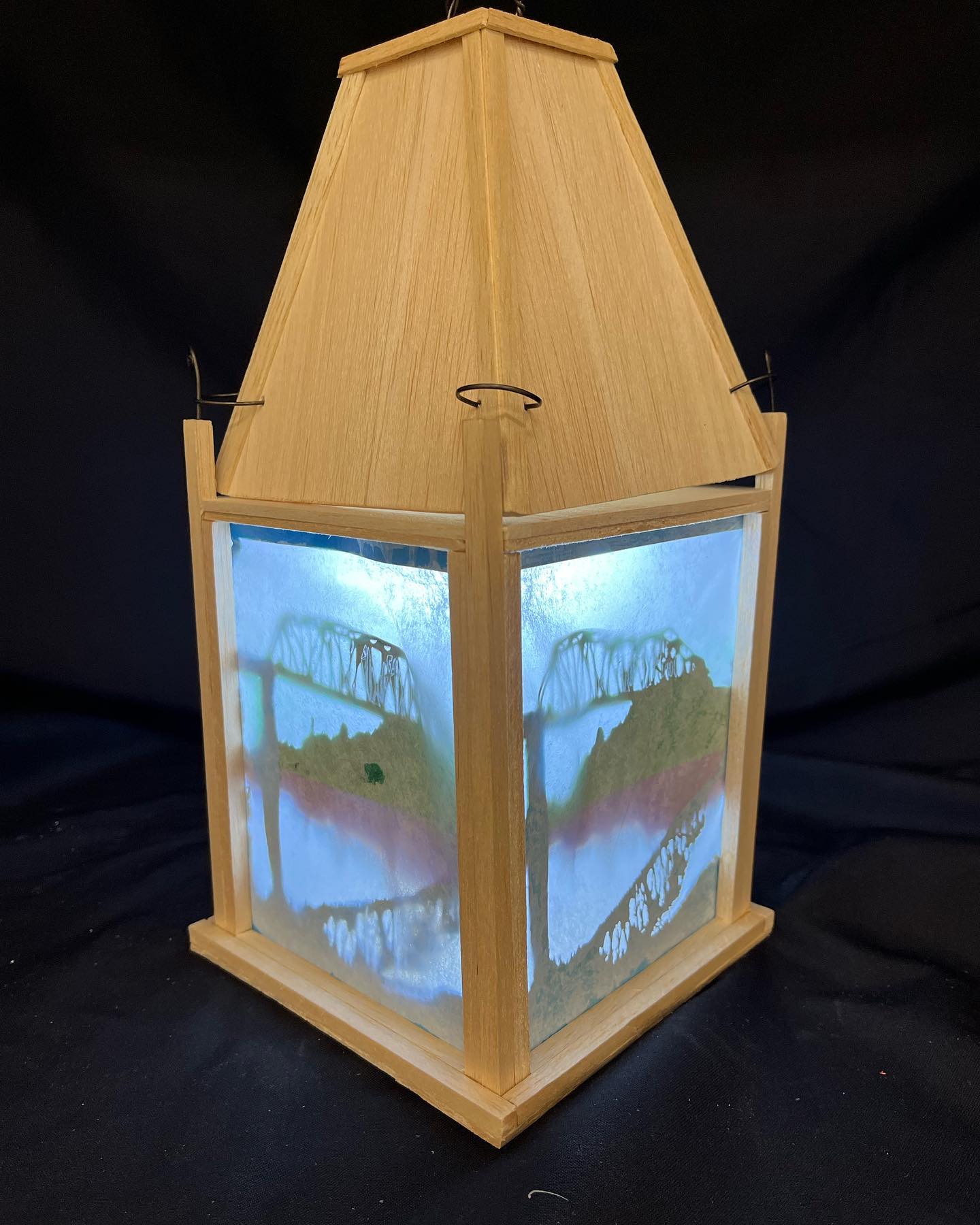 a handmade lantern made of wood and paper