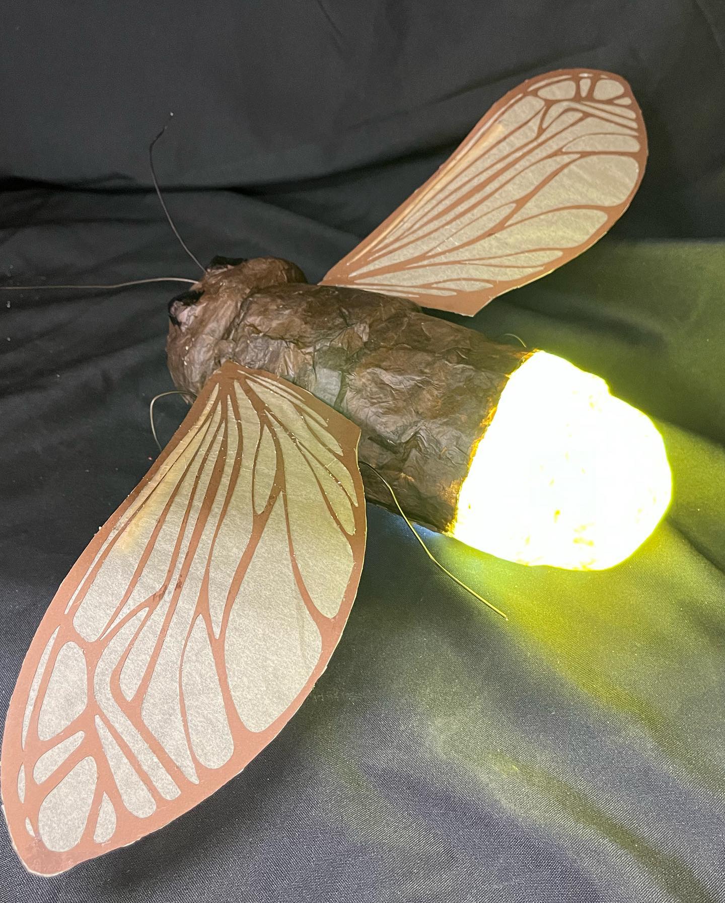 a hand-made lantern shaped like a flying insect