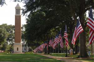 The University of Alabama Quad with U.S. flags lining the sidewalk.