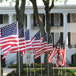 U.S. flags line a sidewalk on the Quad at The University of Alabama