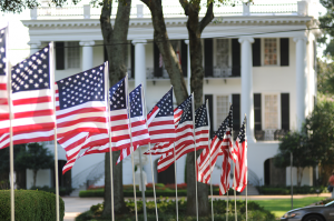 U.S. flags line a sidewalk on the Quad at The University of Alabama