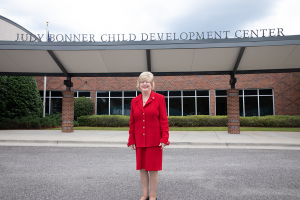 Dr. Judy Bonner stands in front of a building.