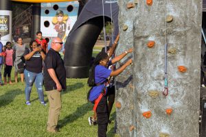 Two people climb a rock wall.