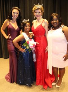 Katherine Hinojosa posing with organizers and participant in the Miss Unique U A pageant