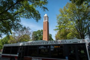 A Crimson Ride bus in front of Denny Chimes at The University of Alabama.