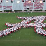 A large number of new students forming the Script A on the field of Bryant Denny Stadium