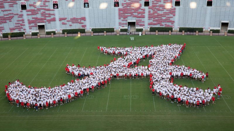 A large number of new students forming the Script A on the field of Bryant Denny Stadium