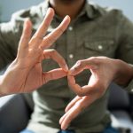 Man Using Sign Language To Communicate At Home