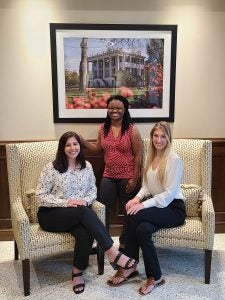 Three women pose for photo in an office at The University of Alabama.