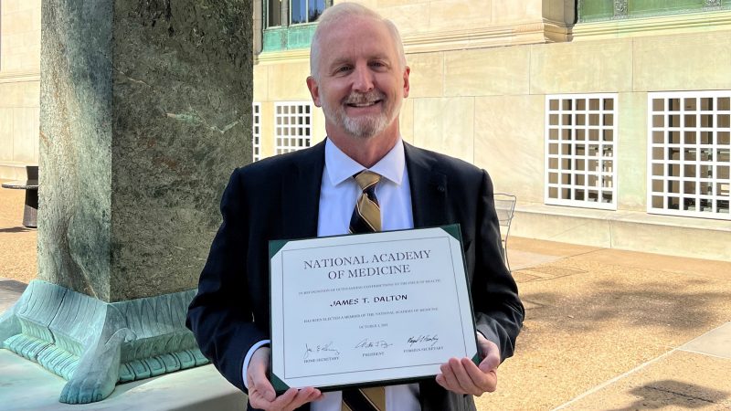 Provost James Dalton holding his National Academy of Medicine certificate