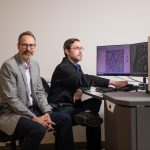Two men at The University of Alabama work on material characterization.