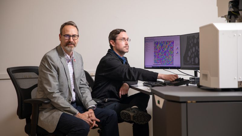 Two men at The University of Alabama work on material characterization.