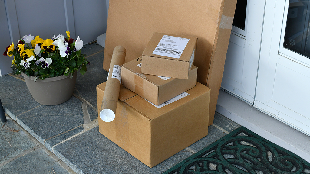 Packages sitting on a front porch.