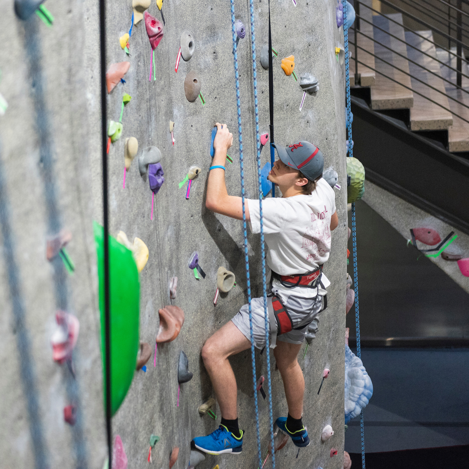 student climbing a climbing wall at the rec center