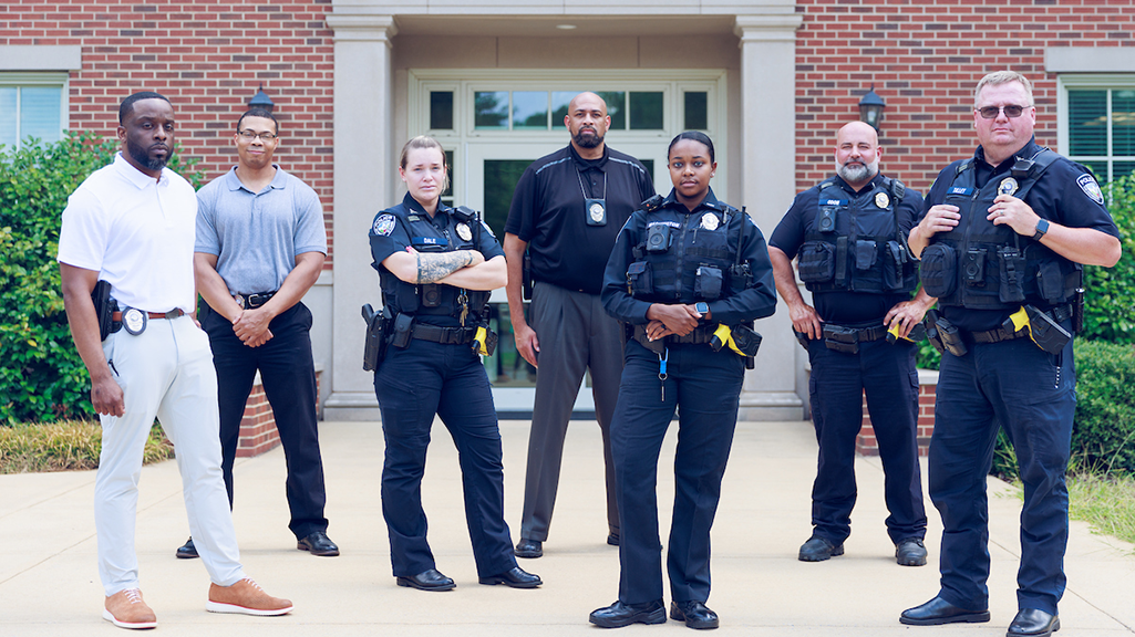 A group of UA police officers standing outside of police headquarters.