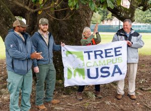 Roy Davis, Sam Boswell and Katie Wiswall of the Alabama Forestry Commission present Bonner Lee with University Lands certification of being named a Tree Campus USA. 