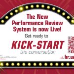A marquee sign stating the new HR performance review system is live.