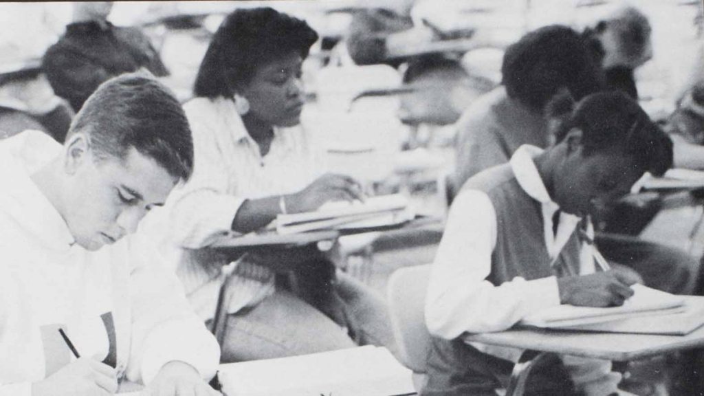African American female student taking notes in class. Courtesy of The University of Alabama Libraries Special Collections.