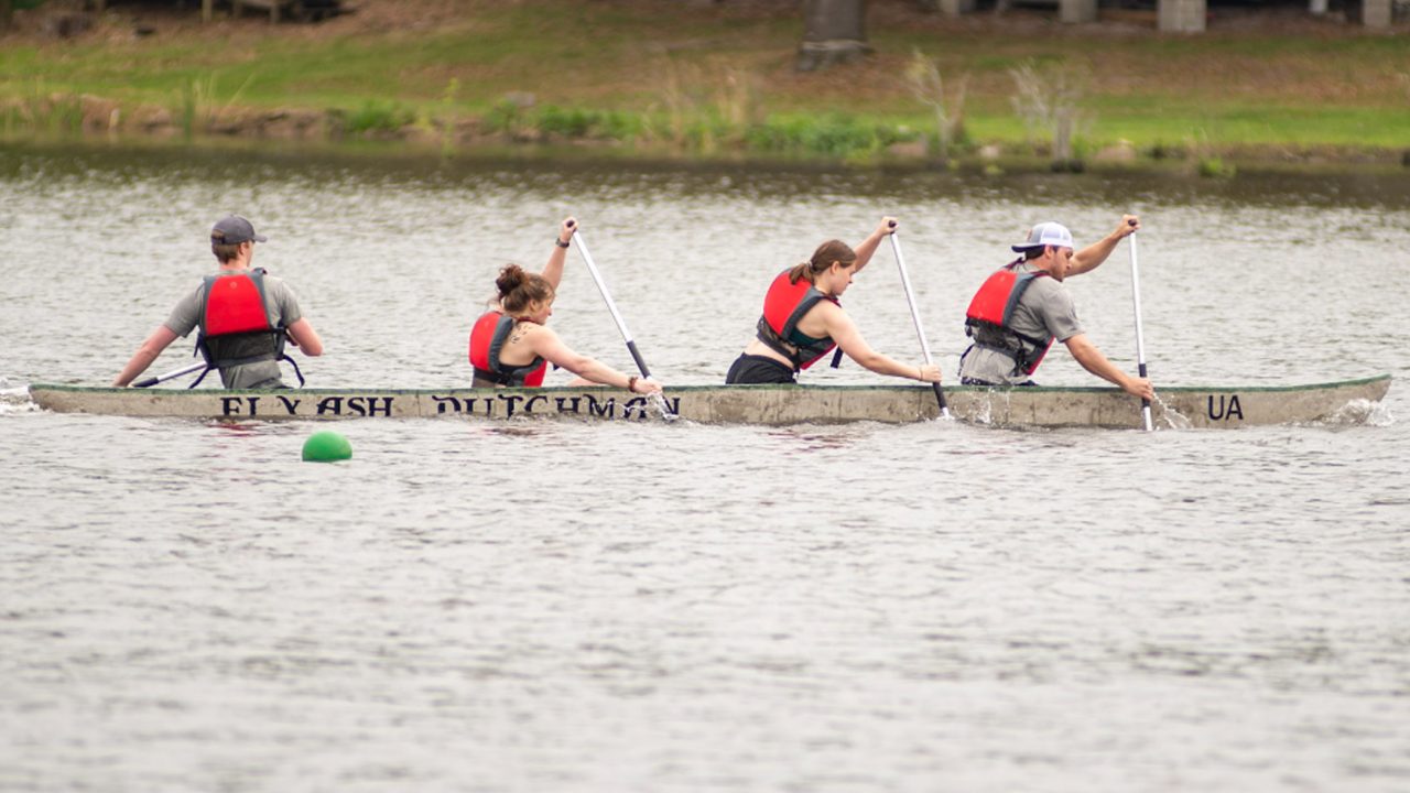 Students row a canoe made of concrete.