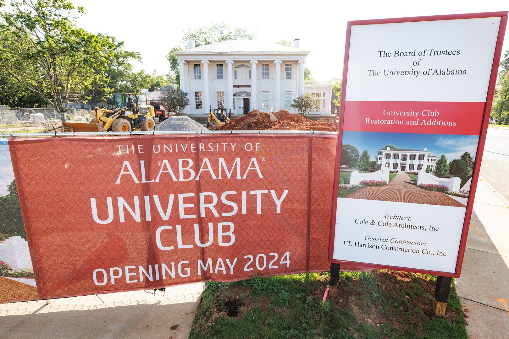 Construction signs frame the an antebellum-style building