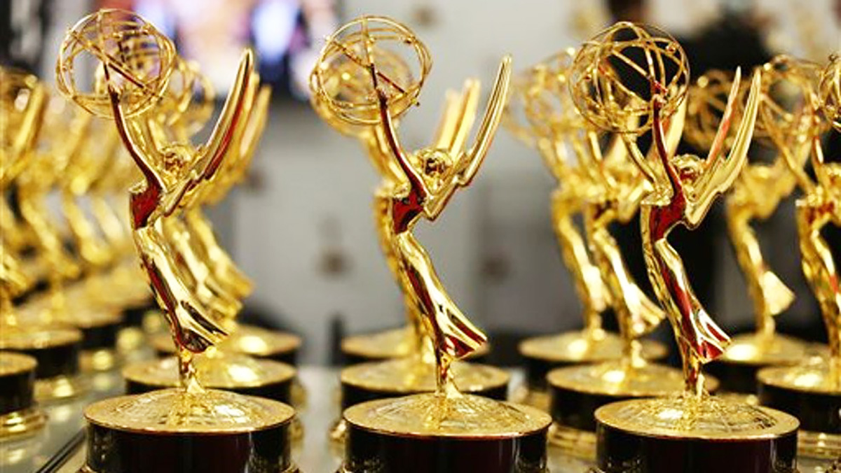 A set of gold Emmy award statues.