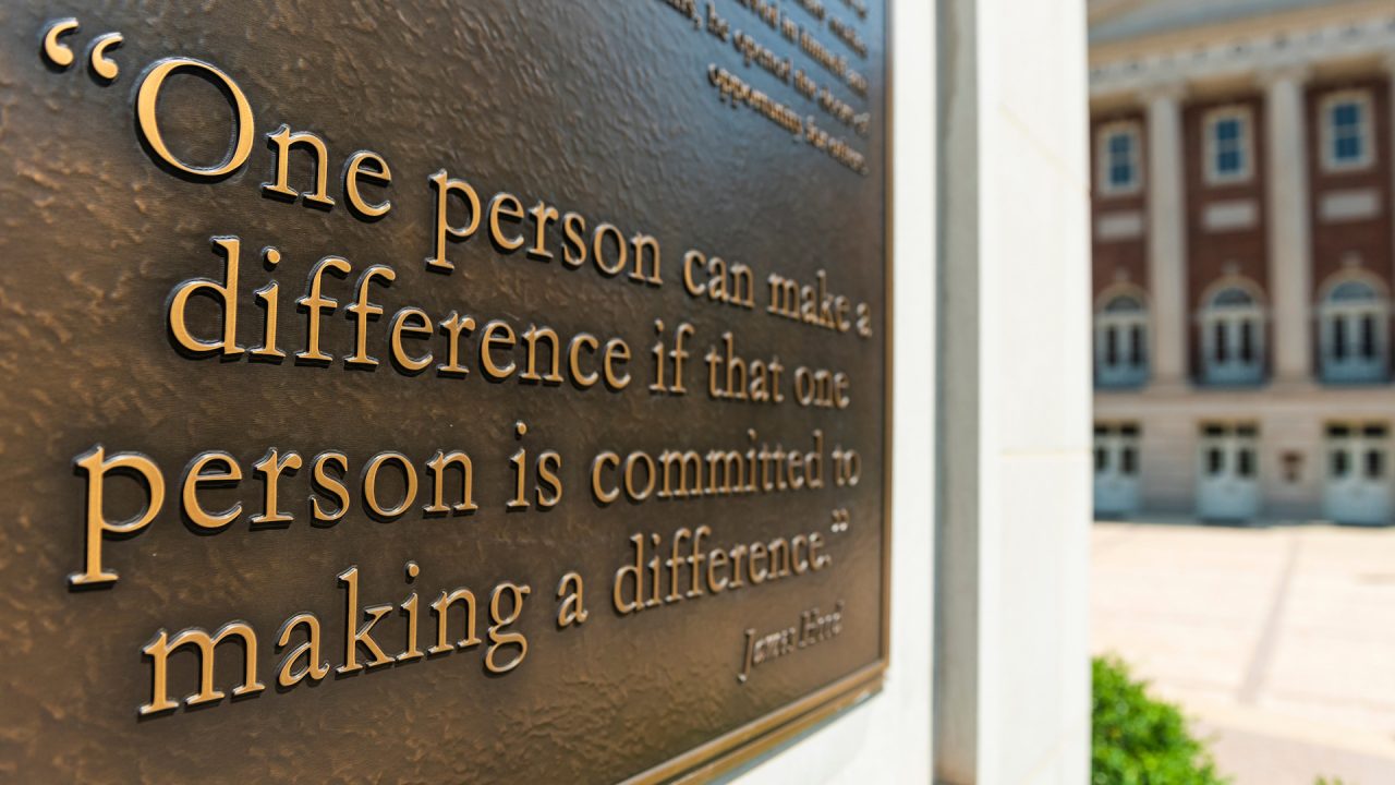 a plaque in the Malone-Hood plaza that reads: "One person can make a difference if that person is committed to making a difference."