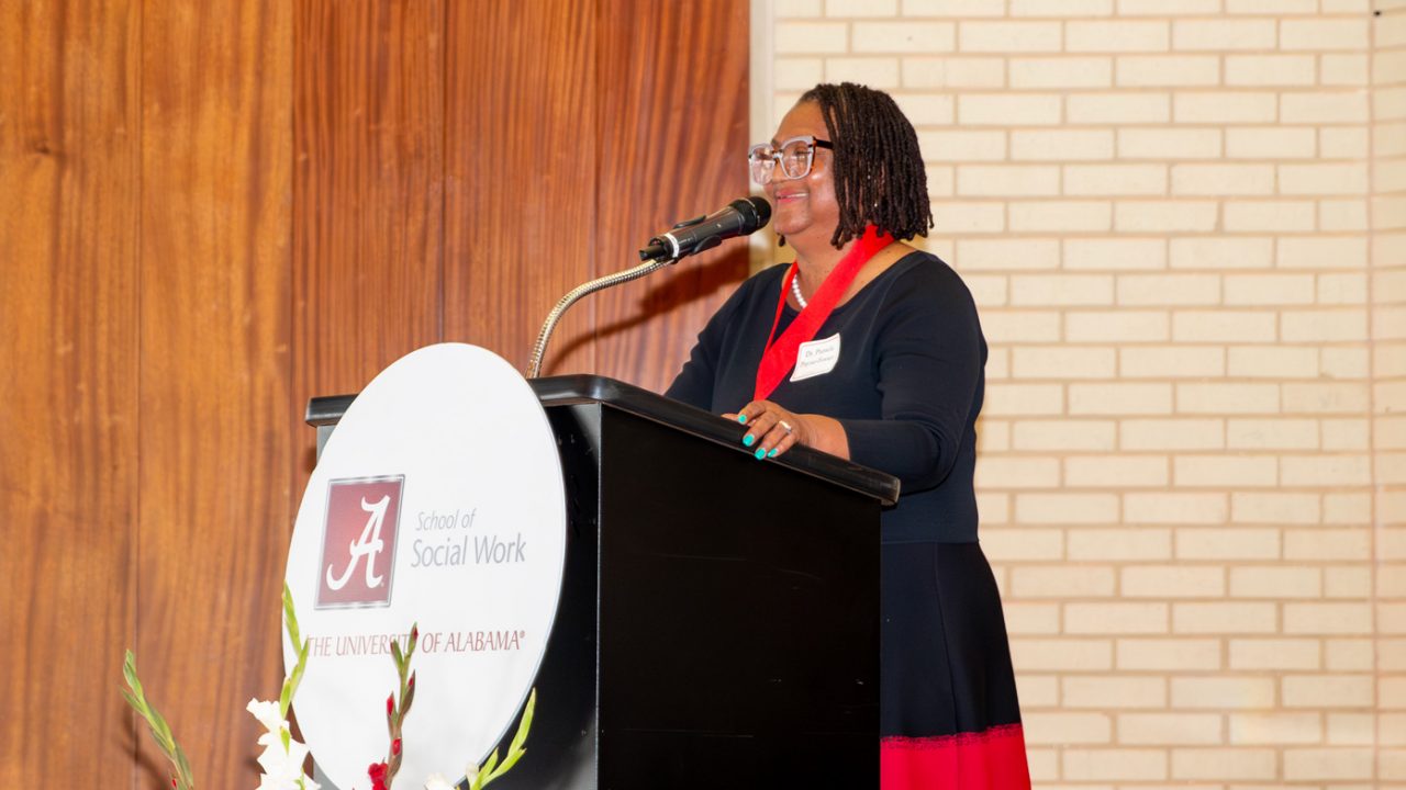 Dr. Pamela Payne-Foster speaking at a podium at the award ceremony