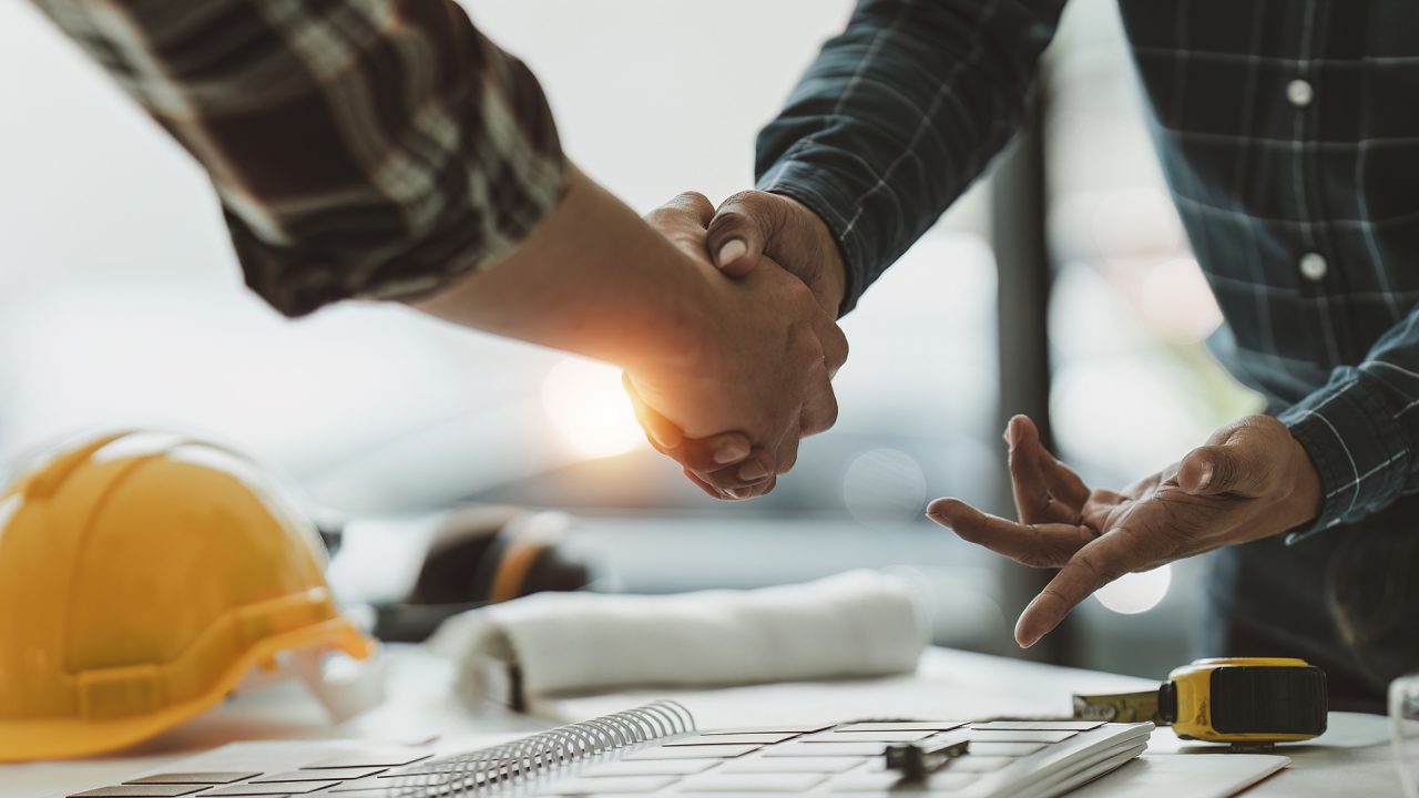 two people shaking hands over a business deal