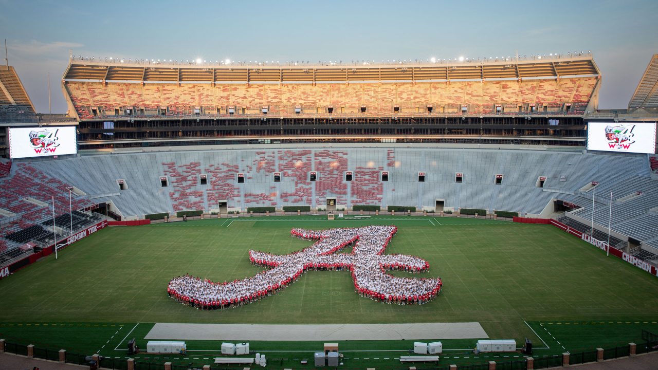 large group of new students create the shape of the script A inside Bryant-Denny Stadium