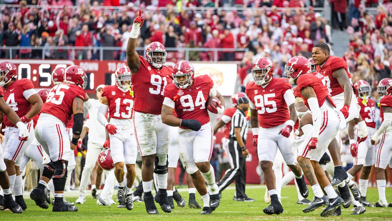 alabama football players celebrate after a great play