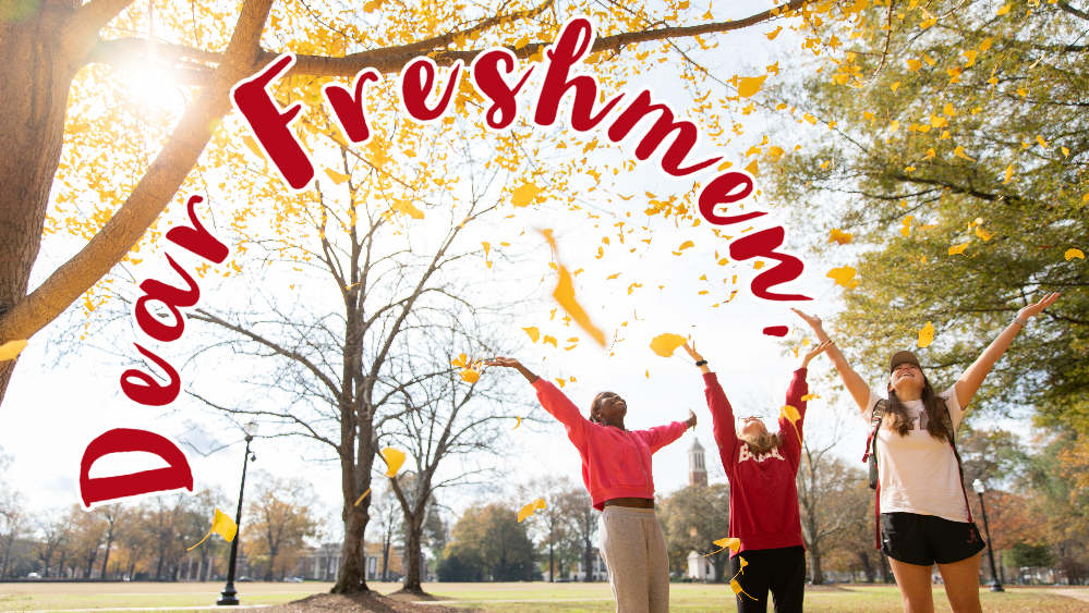 three young women throw leaves in the air on the Quad while smiling with the words "Dear Freshmen" written in script in the air