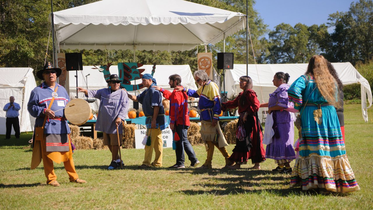 A group of dancers performing a Native American dance