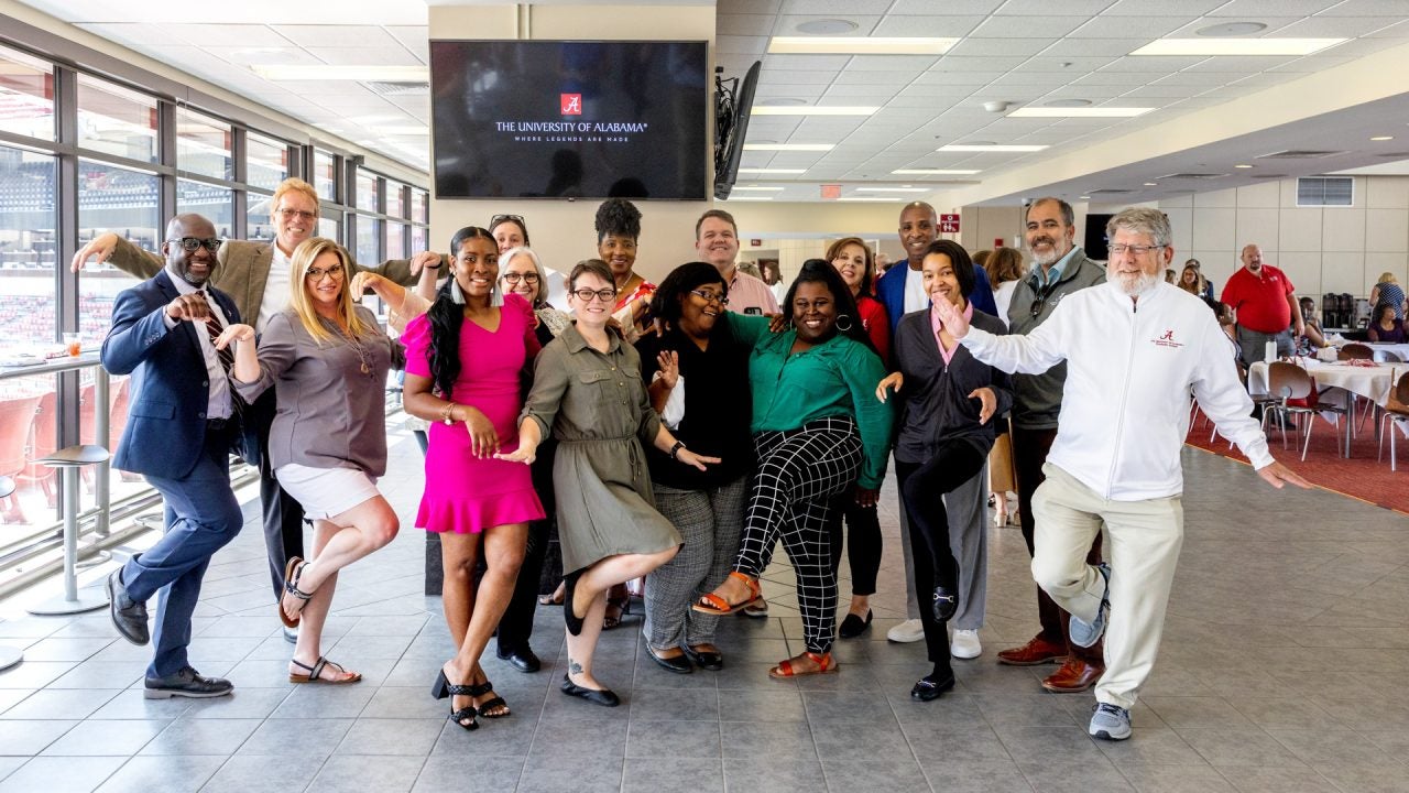 group of staff members strike a silly pose