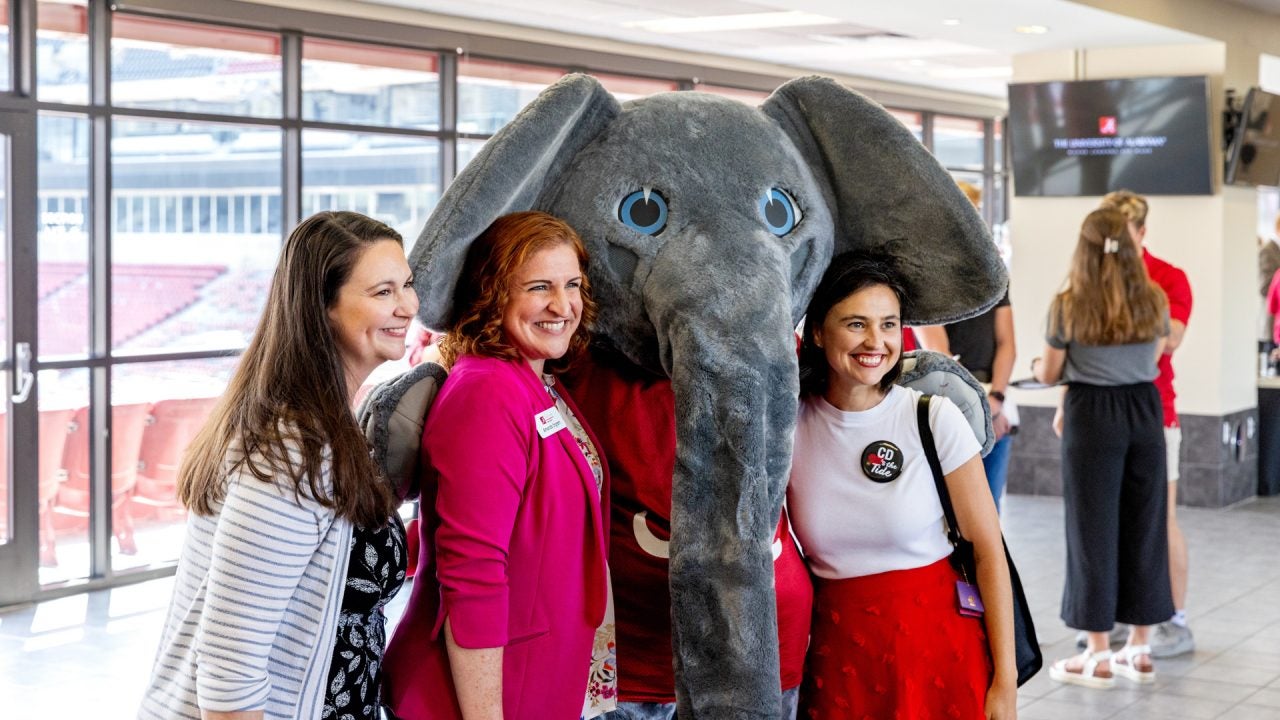 group of women pose for a picture with Big Al