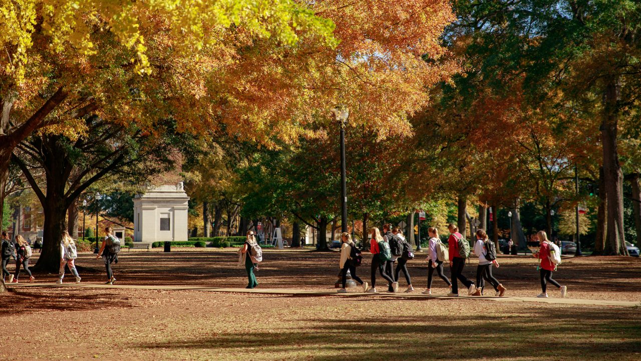 students walking across the Quad during autumn