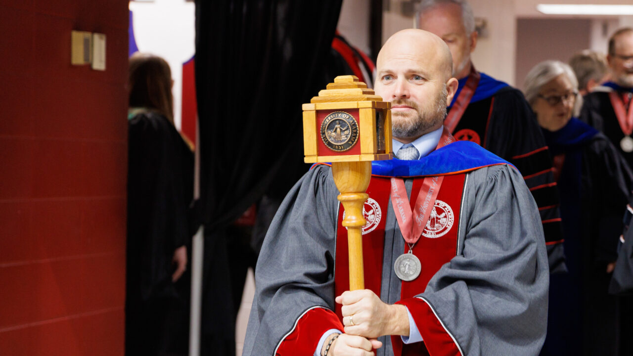 faculty member holds the ceremonial mace